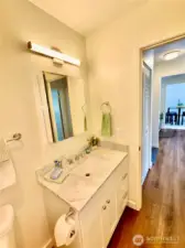 All new bath fixtures. Quartz counters here too. New laminated wood flooring thru to the dining area.