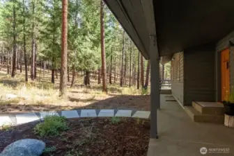 Walkway to front door and covered aggregate patio.