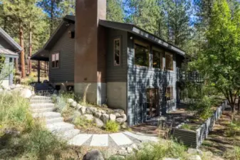 Stone steps from Garage on the SW corner of home leads to Terrace and Bonus room french doors.