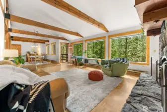 Beautiful inspired living area on main level offer bright natural light and views. Door to wood deck walkway that is covered for year round use.