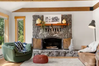 Living room speaks comfort and relaxed space in front of Methow Rock fireplace. Hardwood floors.