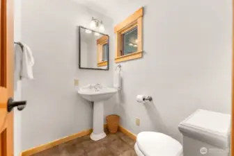 Three quarter Bath on Main level of home. Ceramic tile floor, pedestal sink, toilet.