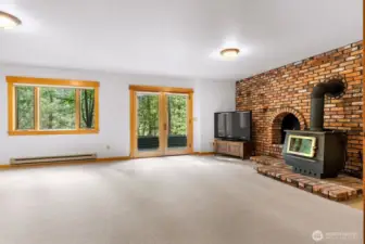 Daylight walkout basement Bonus room is plumbed for wet bar if desired, White wool carpet is luxurious. Wood heat fireplace on vintage brick hearth and accent wall. French doors open to Terrace area.