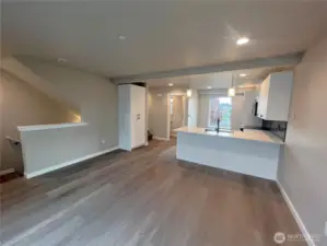 Living/kitchen with door to left to powder room