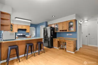 Kitchen has built in desk, many cabinets, and counter room for eating. Home will come with all appliances