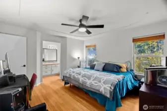 Primary bedroom has large windows with lots of light.