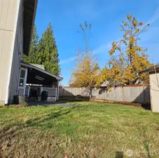 One view of large fenced backyard. Raised beds,covered patio, wired for hot tub.
