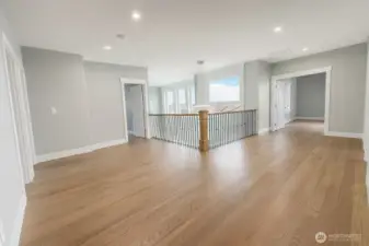 HUGE loft area on the second floor! This showcases the oak hardwood, custom handrail and gorgeous finishing work.