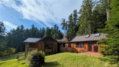 Tucked into the hillside on this sunny south facing property. Windows and skylights delight with dancing light throughout this home.