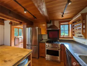 Custom cabinets and a huge kitchen island blend perfectly with the original charm of the log cabin.