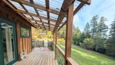 The large covered porch of the guest studio is a wonderful extension of the space. Set away from the main house for privacy.