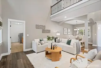 Comfortable great room with dining room in the back.  Door leads to the large laundry room and to the garage.