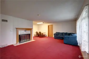 Enjoy this spacious living room with lots of sunlight and cozy wood fireplace.