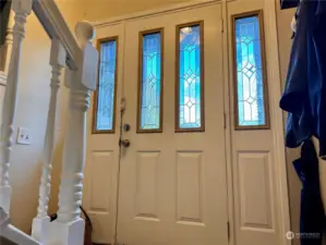 Beveled glass front door with side lights.