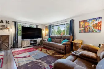 Generous living room with wood burning fireplace.