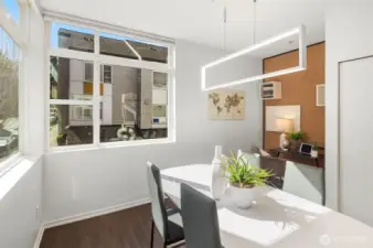 Spacious, sunny dining room features motorized blinds. The room is llarge enough for a work space.