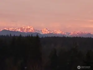 Wake up to the glow of the Olympic Mountains