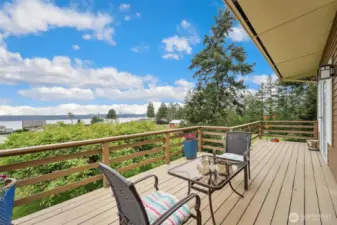 Lovely large deck with dining room and primary bedroom access.  Sit back relax and enjoy the views of Saratoga Passage and the Olympic Mountains.