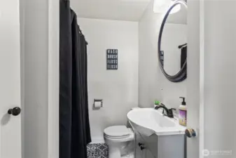 Full bathroom in hallway between primary and other bedroom.