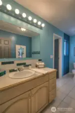 New lighting fixtures and vanity in guest upper bathroom