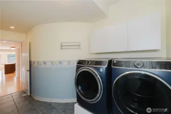 Laundry room with a radius off the kitchen and access to a 3-car garage offers convenience and elegance.