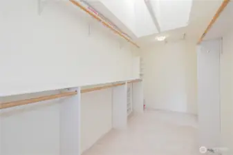 Primary walk-in closet with skylights.