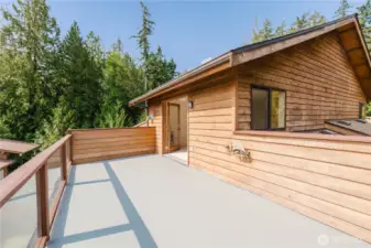 Imagine waking up in your primary bedroom, where gentle morning light filters through the French doors. Stepping onto your private deck, you're greeted by fresh air and a breathtaking view. It's perfect for enjoying a coffee or unwinding in the evening. This space blends indoor comfort with outdoor beauty, making your home a true sanctuary.