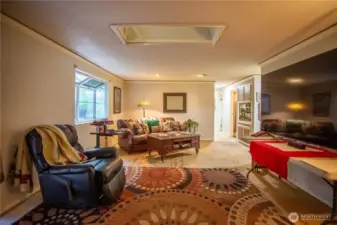 living room with garden window, skylight, looking to the hall