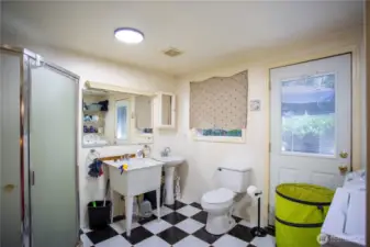 Huge utility 3/4 bathroom with exit door to the back deck. Washer and dryer stays