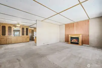 Living room opens to the dining room and kitchen.