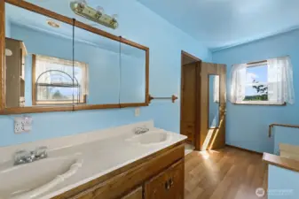 Primary bathroom is roomy and comfortable for two people at one time.