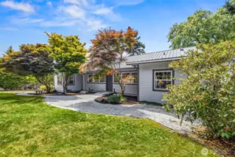 From the west gate, a gently winding pathway leads you through the natural landscape toward the home’s front entrance—setting the tone for the peaceful, private, and historic charm that awaits on this unique Samish Island property.