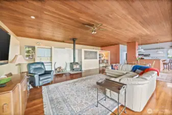 The inviting living room features a classic wood-burning fireplace to keep you warm on chilly island nights, along with a built-in wet bar—perfect for entertaining or relaxing with a view.