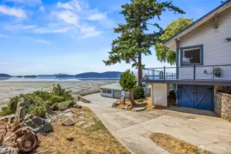 Looking down the driveway and boat ramp beneath the home, you'll find a convenient work area complete with a bench and additional storage—ideal for marine gear, tools, or projects.