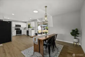 Bright dining area flows seamlessly from the kitchen with direct backyard access