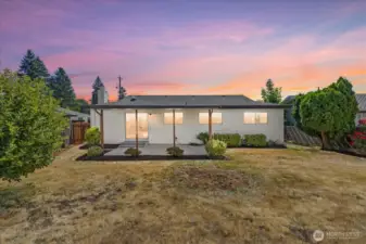 Fully fenced backyard with a covered patio—perfect for summer BBQs or relaxing mornings
