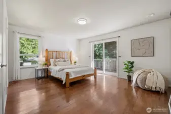 Primary bedroom with easy access to the back deck an en-suite updated bathroom with a large walk in shower and 3 closets!