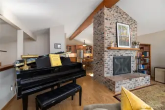 Spacious living room with vaulted ceilings and wood burning fireplace.
