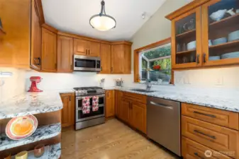Fully refreshed kitchen with beautiful wood cabinetry, granite counters, stainless appliances and so much storage.