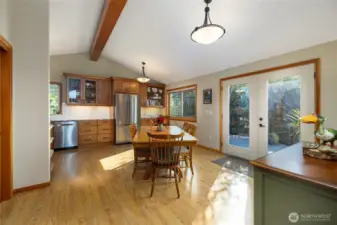 Open concept dining room and kitchen with vaulted ceilings and french doors that open to a wonderful deck.