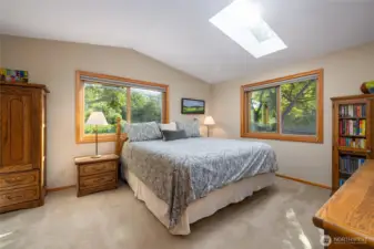 Private, primary suite with scenic views of the beautifully landscaped back yard.