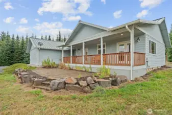 Covered Trex deck and paver patio invite you to relax and take in the front yard and pond views.