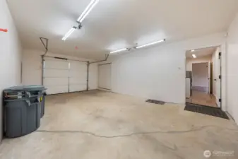 Attached single garage with newer hot water heater and furnace; direct access to laundry room with counter, sink, and storage.