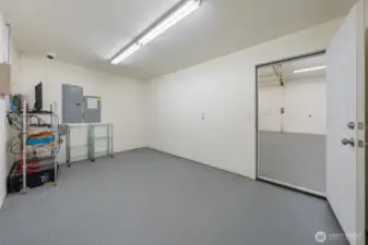 Office inside shop featuring monitored security system and generator panel.