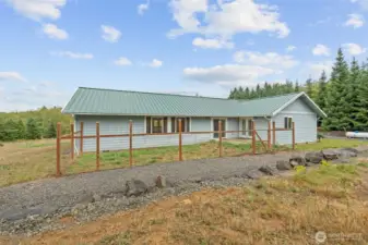 Back view of home and fenced yard: perfect for pets or play.