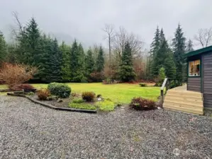 Side of house with front deck and parking access