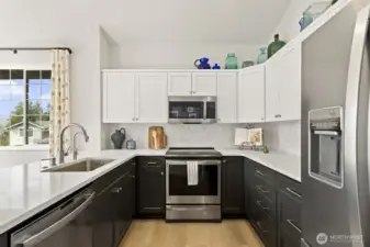 Newer stainless steel appliances, quartz countertops, new cabinets and stylish hex tile backsplash - wow!