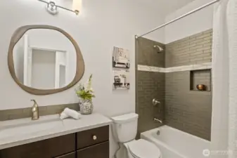 Full remodeled bathroom off of the hallway, perfect for guests.