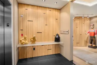 Elevator opens into the private vestibule. Designer ash wood wall with metal set-ins and custom cut-glass attached table is very welcoming and inviting.