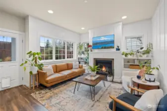 Open and airy living space with an abundance of windows and gas fireplace to warm the cooler nights.